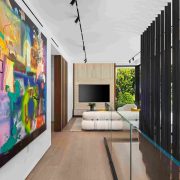 Hallway with contemporary art and minimalist design inside modern Sunset Islands home.