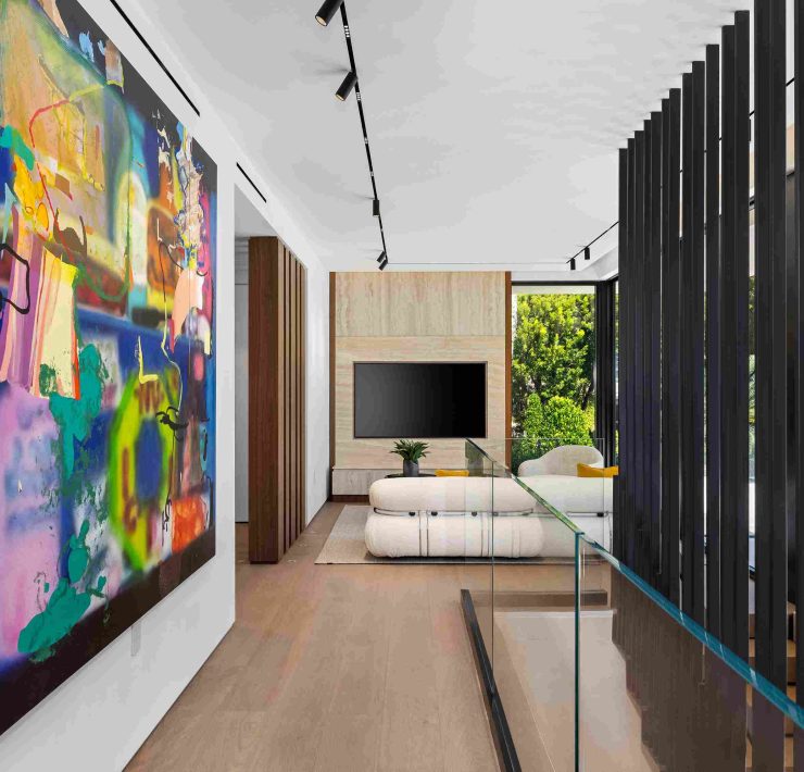 Hallway with contemporary art and minimalist design inside modern Sunset Islands home.