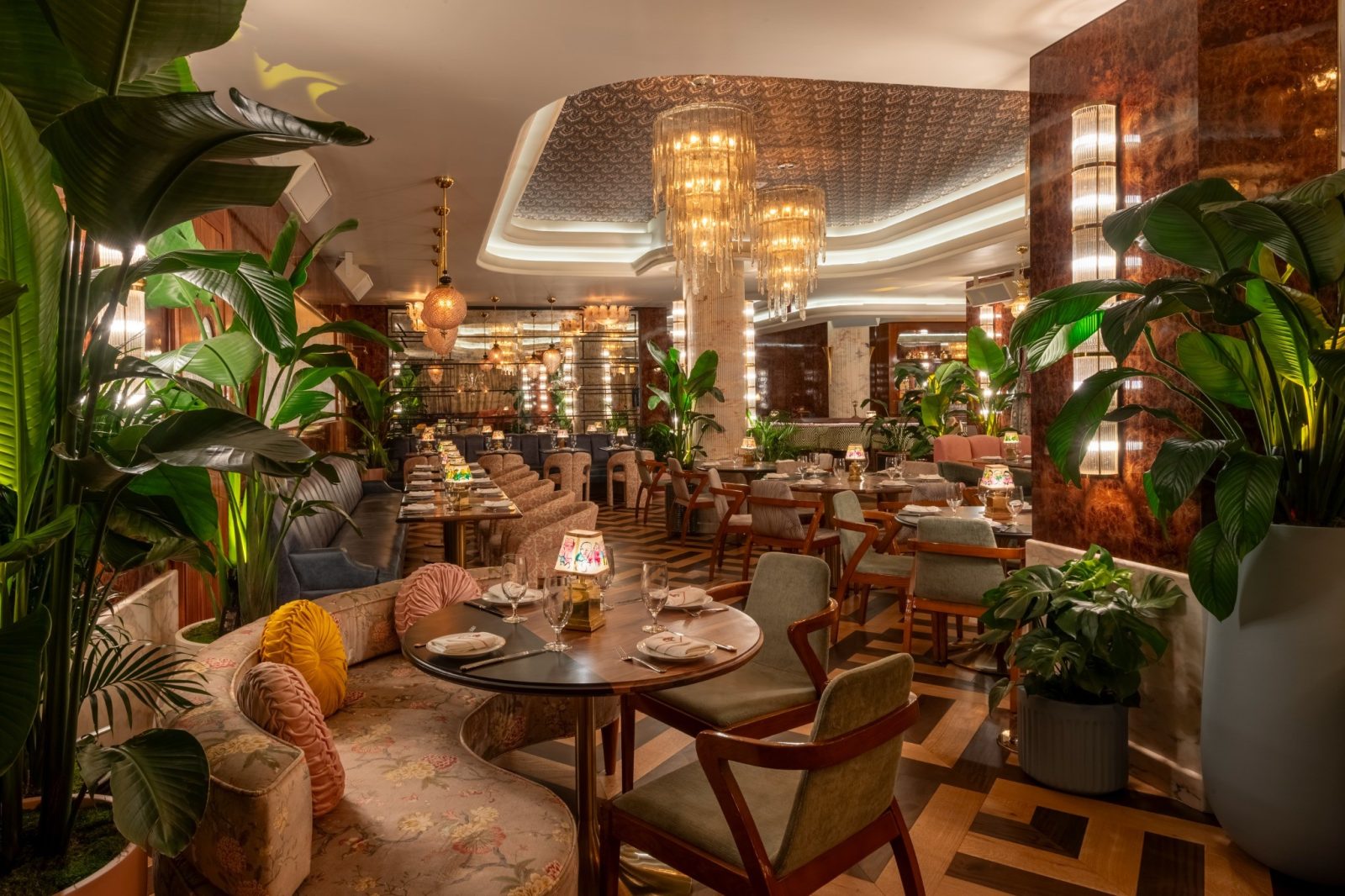 Interior of The Goodtime Hotel restaurant in South Beach with art deco design and chandeliers.