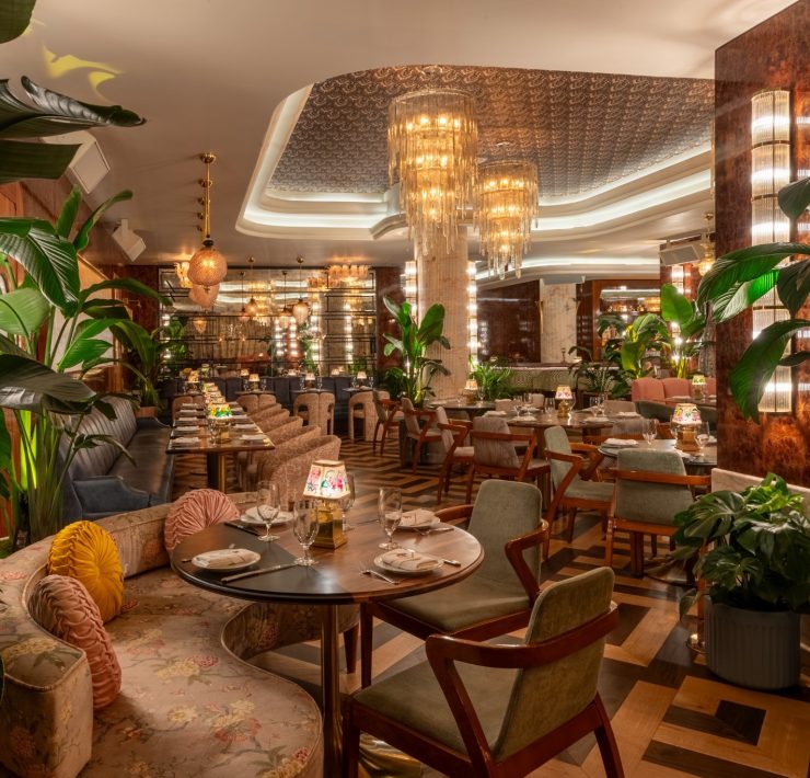 Interior of The Goodtime Hotel restaurant in South Beach with art deco design and chandeliers.
