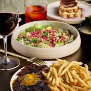 Wagyu steak frites with salad and red wine at ADRIFT Mare Brickell.