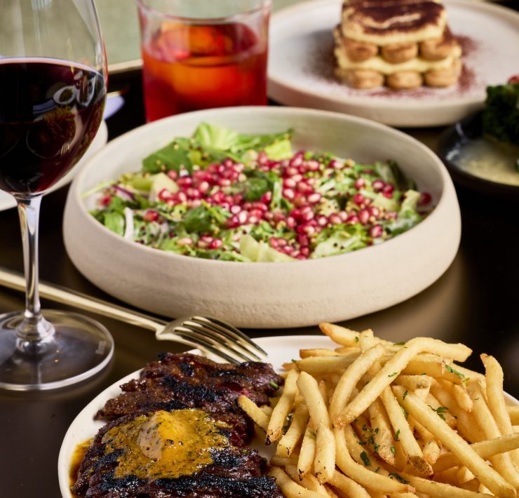 Wagyu steak frites with salad and red wine at ADRIFT Mare Brickell.