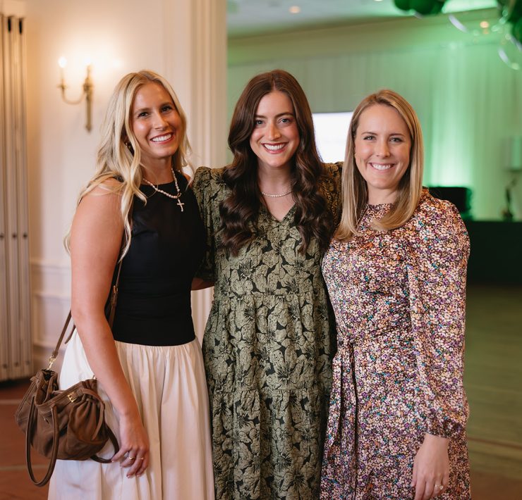 Guests posing for a photo at the Both Ends Believing “Around the World” Gala celebrating global child welfare.