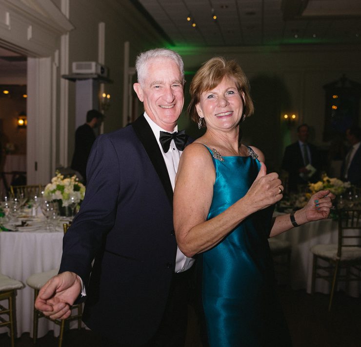 Elegant couple celebrating and dancing at Both Ends Believing’s “Around the World” Gala.
