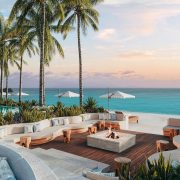 Outdoor lounge with fire pit and ocean view at Nikki Beach Resort & Spa Antigua.