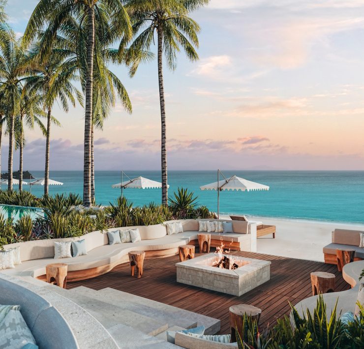 Outdoor lounge with fire pit and ocean view at Nikki Beach Resort & Spa Antigua.