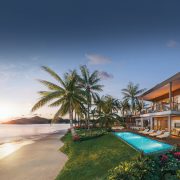 Private beachfront villa with infinity pool and palm-lined coastline at Nikki Beach Antigua.