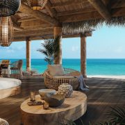 Oceanfront terrace with natural wood design and sea views at The Residences at Nikki Beach Resort & Spa Antigua.