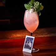 Pero Liiiike cocktail at Mama Tried Miami, made with dragon berry tequila, guava, lime, apricot liqueur, and ginger beer, served with a Polaroid photo.