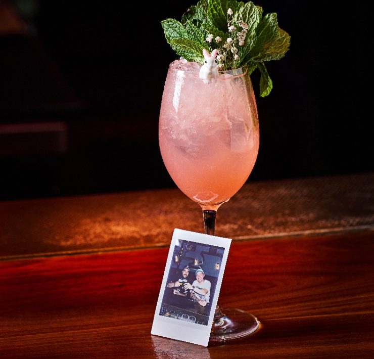 Pero Liiiike cocktail at Mama Tried Miami, made with dragon berry tequila, guava, lime, apricot liqueur, and ginger beer, served with a Polaroid photo.