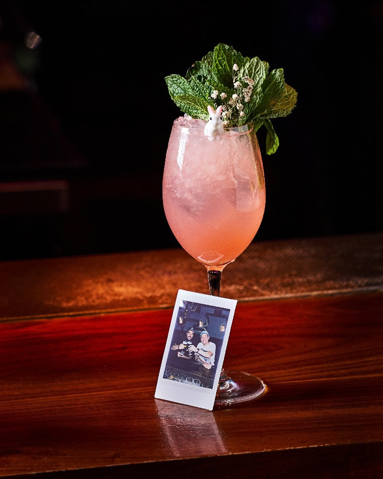 Pero Liiiike cocktail at Mama Tried Miami, made with dragon berry tequila, guava, lime, apricot liqueur, and ginger beer, served with a Polaroid photo.