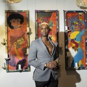 Artist posing with contemporary art pieces at The Betsy South Beach gallery exhibition for Miami Art Week.