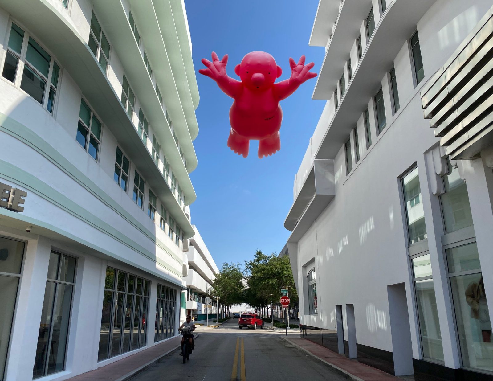 ublic art installation featuring a pink inflatable figure on Lincoln Road during Miami Art Week 2025.