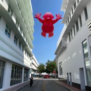 ublic art installation featuring a pink inflatable figure on Lincoln Road during Miami Art Week 2025.