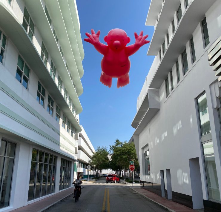 ublic art installation featuring a pink inflatable figure on Lincoln Road during Miami Art Week 2025.