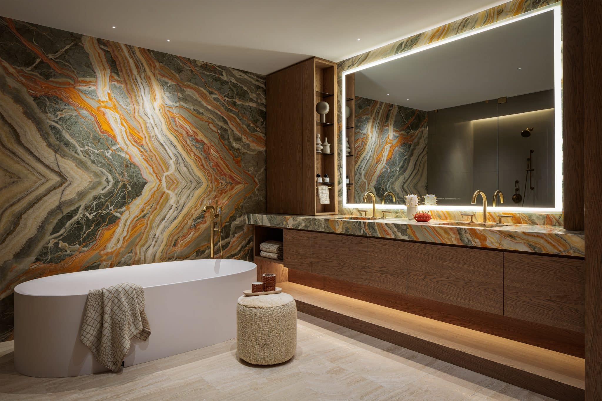 Luxurious primary bathroom with sage and orange onyx, oak cabinetry, tinted bronze glass, and custom closet display.