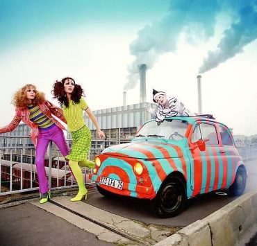 Editorial-style art photograph of models and a painted vintage car displayed during Miami Art Week exhibitions.