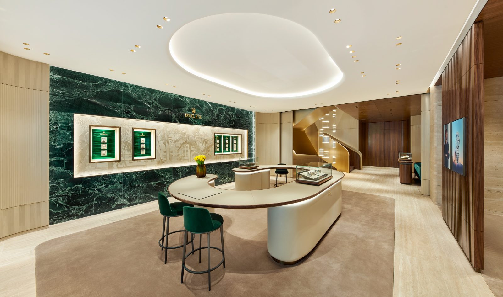 Main showroom interior featuring green stone wall displays and curved consultation counter in Miami Design District boutique