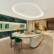 Main showroom interior featuring green stone wall displays and curved consultation counter in Miami Design District boutique