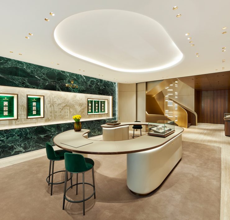 Main showroom interior featuring green stone wall displays and curved consultation counter in Miami Design District boutique