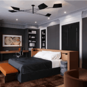 Dark modern bedroom with custom built-ins, black paneled walls, warm wood accents, and integrated desk