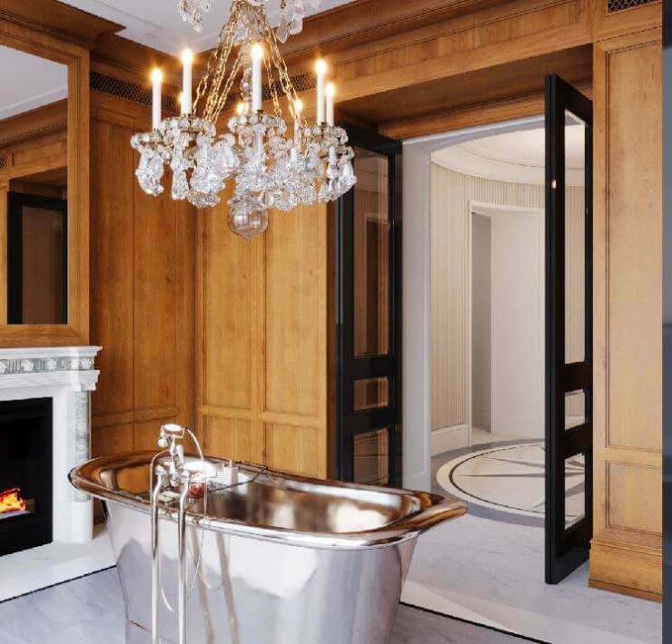 Luxury bathroom with warm wood paneling, crystal chandelier, freestanding metal tub, and marble fireplace
