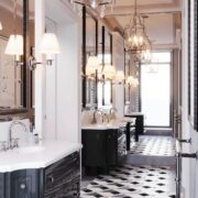 Elegant black-and-white bathroom with patterned tile floor, double vanity, and hanging lantern-style lights