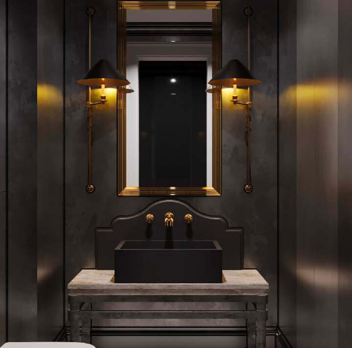 Moody powder room with dark walls, black vessel sink, stone console, and brass sconces
