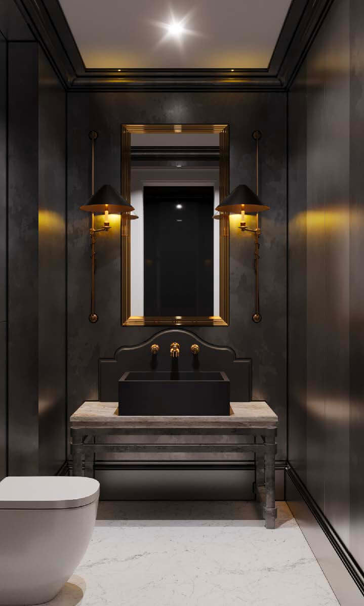 Moody powder room with dark walls, black vessel sink, stone console, and brass sconces