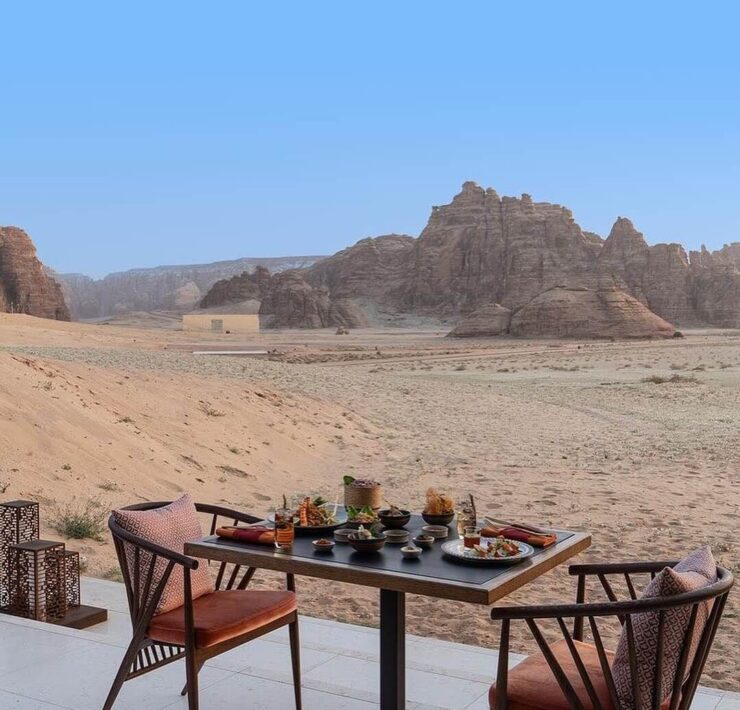 Desert-view outdoor dining terrace with modern table setting overlooking dramatic rock formations