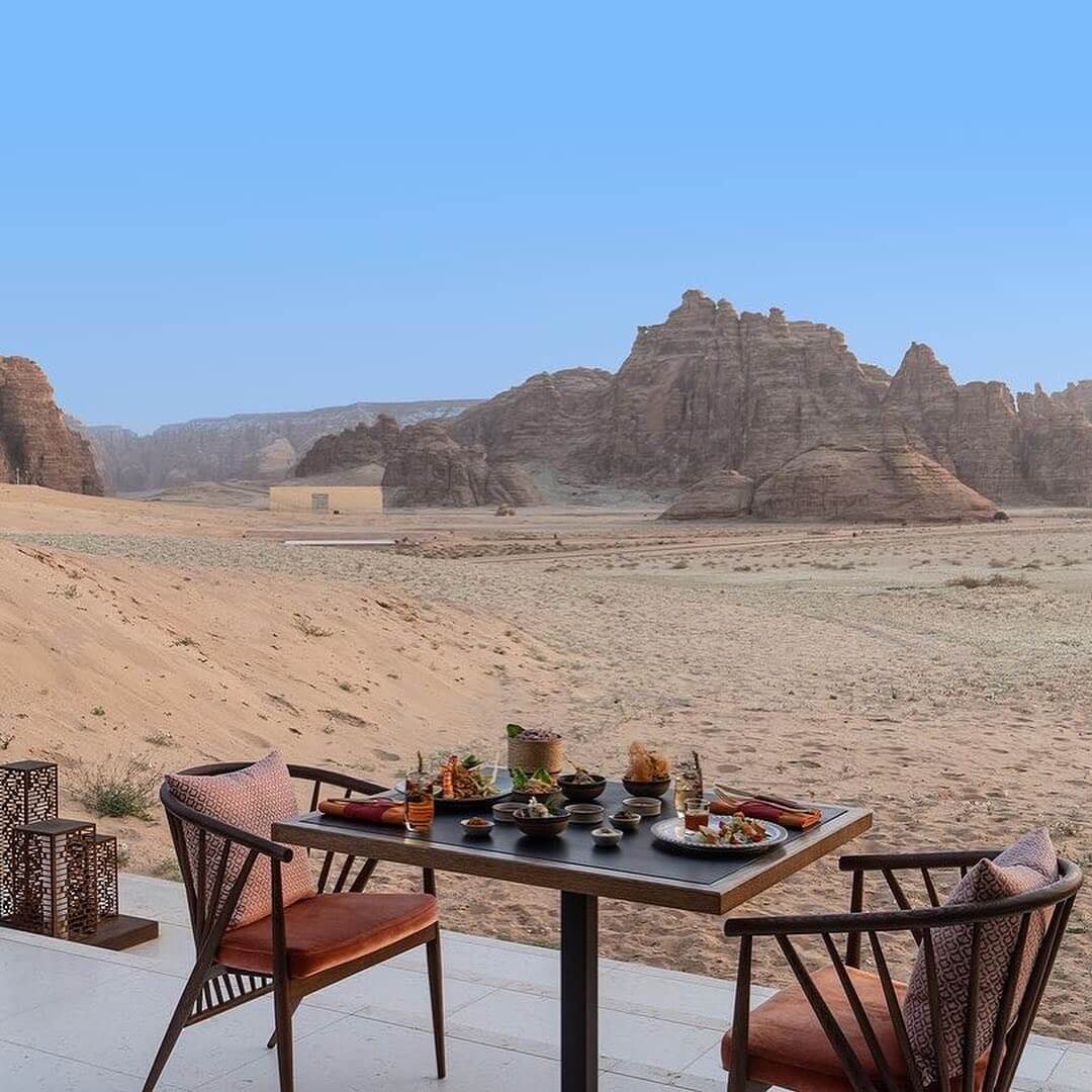 Desert-view outdoor dining terrace with modern table setting overlooking dramatic rock formations