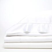 Trousseau Cairo Collection white bedding with elegant embroidered detail and crisp layered sheets