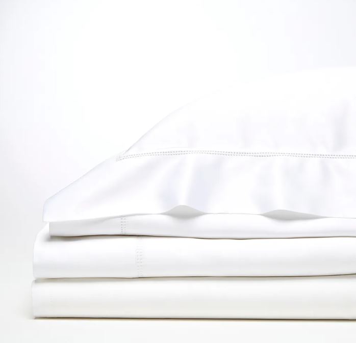 Trousseau Cairo Collection white bedding with elegant embroidered detail and crisp layered sheets