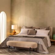 Trousseau Domino Collection bedding in a refined neutral bedroom with layered pillows and soft contemporary styling