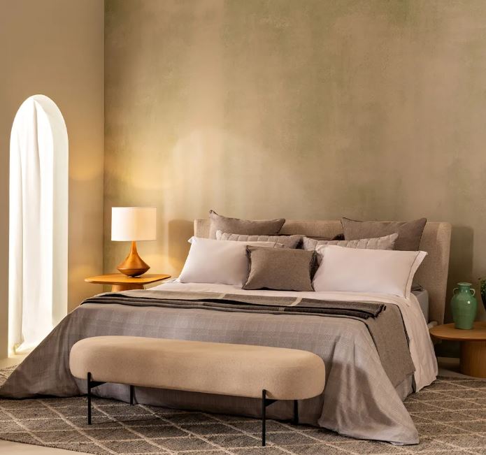 Trousseau Domino Collection bedding in a refined neutral bedroom with layered pillows and soft contemporary styling