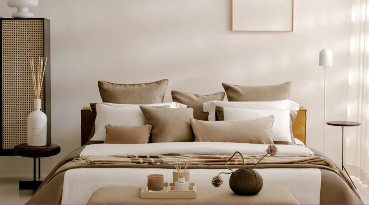 Trousseau Dune Collection bedding styled in a soft neutral bedroom with layered pillows and warm natural textures