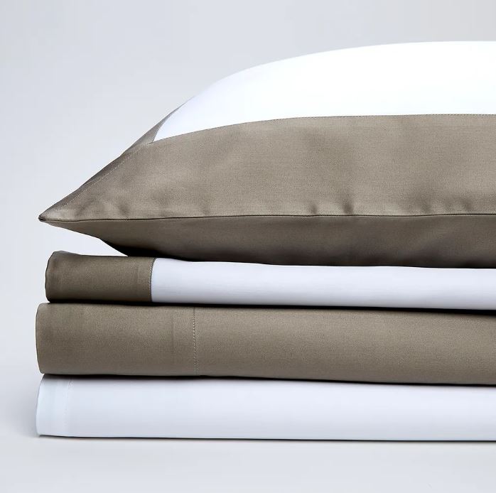 Trousseau Dune Collection bedding with white and taupe sheets, pillowcases, and refined layered details