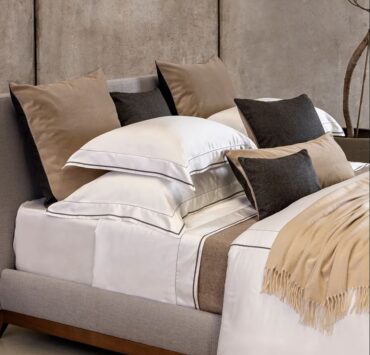 Trousseau Garda Collection bedding with taupe accents, layered sheets, and smooth upscale cotton textures