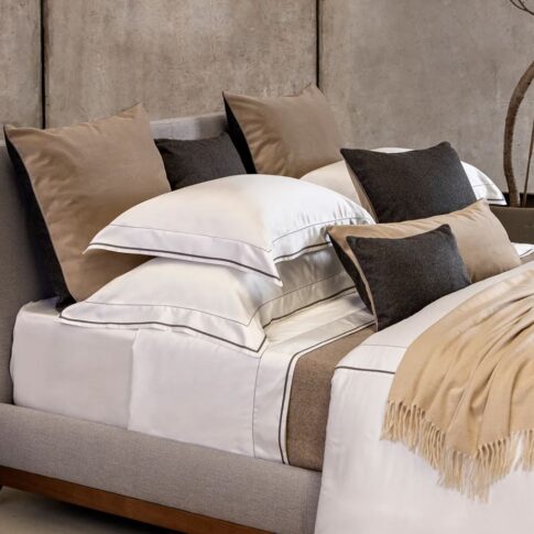 Trousseau Garda Collection bedding with taupe accents, layered sheets, and smooth upscale cotton textures