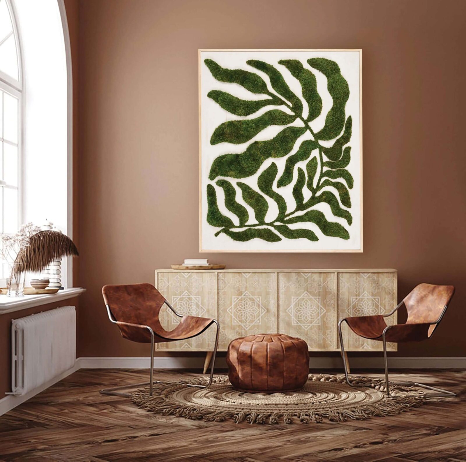 Moss botanical wall art above a console in a warm, natural interior design setting