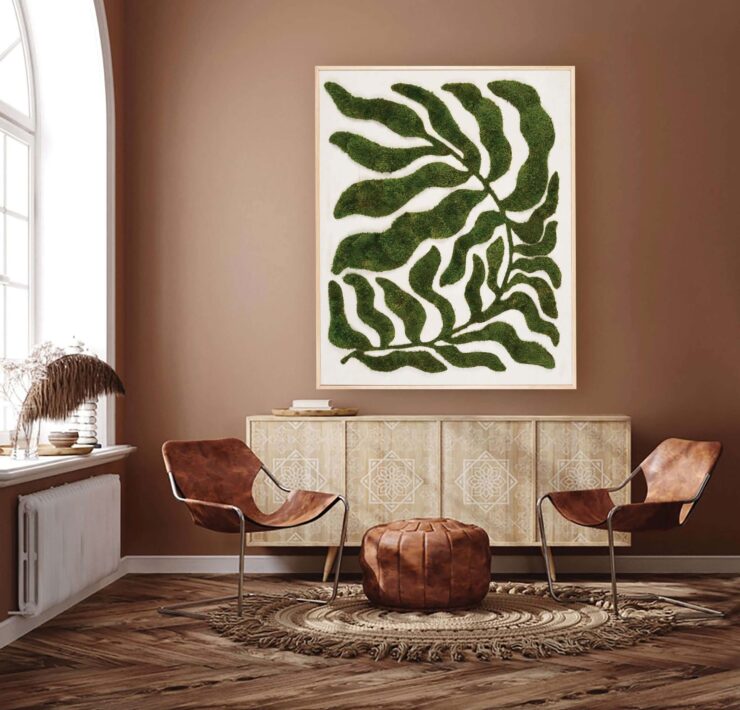 Moss botanical wall art above a console in a warm, natural interior design setting