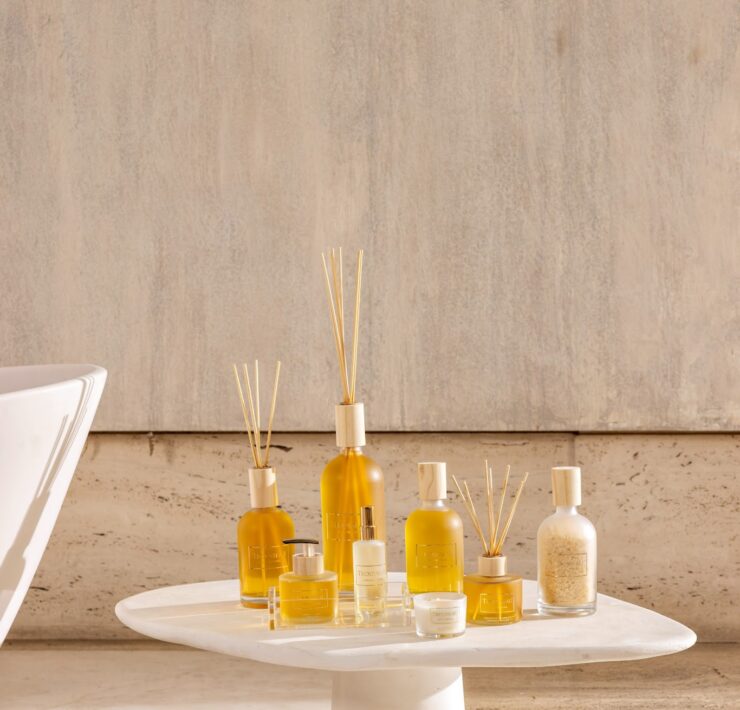 Trousseau Printemps Collection home fragrance with diffusers, candles, and room sprays on a sculptural white table