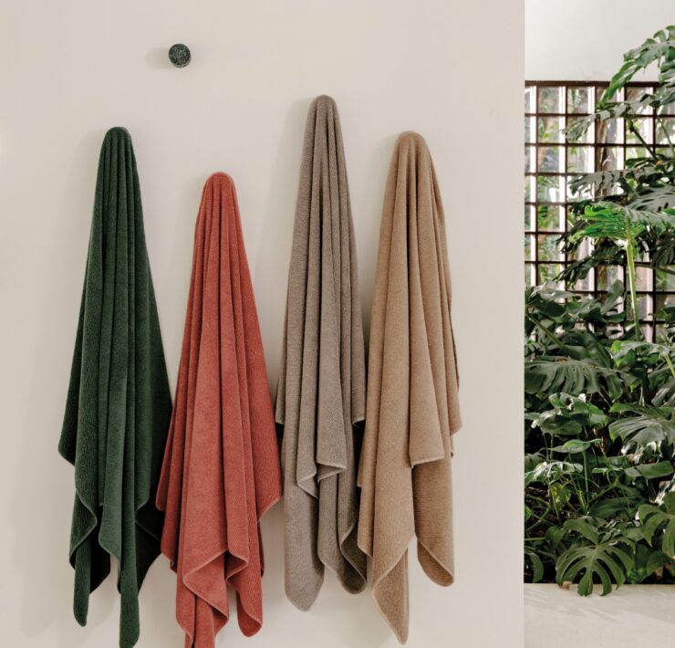 Trousseau Twill Towel collection with colorful bath towels in green, coral, beige, and taupe tones