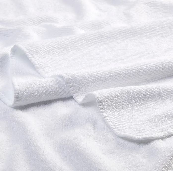 Trousseau Twill Towel close-up in white cotton with soft texture and refined woven edge detail
