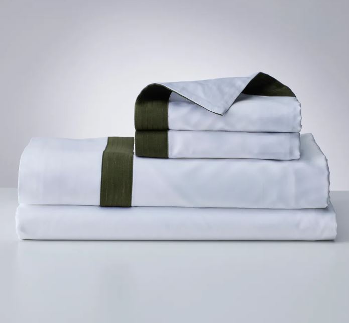 Trousseau Verdeluce Collection white bedding with deep green border trim and crisp folded sheet details