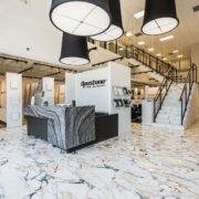 Opustone showroom with marble floors, large stone slab displays, modern tile concepts, and luxury surface materials