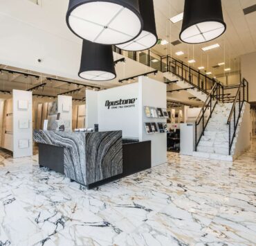 Opustone showroom with marble floors, large stone slab displays, modern tile concepts, and luxury surface materials