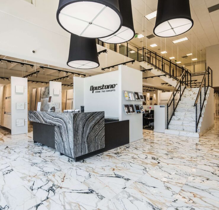 Opustone showroom with marble floors, large stone slab displays, modern tile concepts, and luxury surface materials