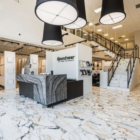 Opustone showroom with marble floors, large stone slab displays, modern tile concepts, and luxury surface materials