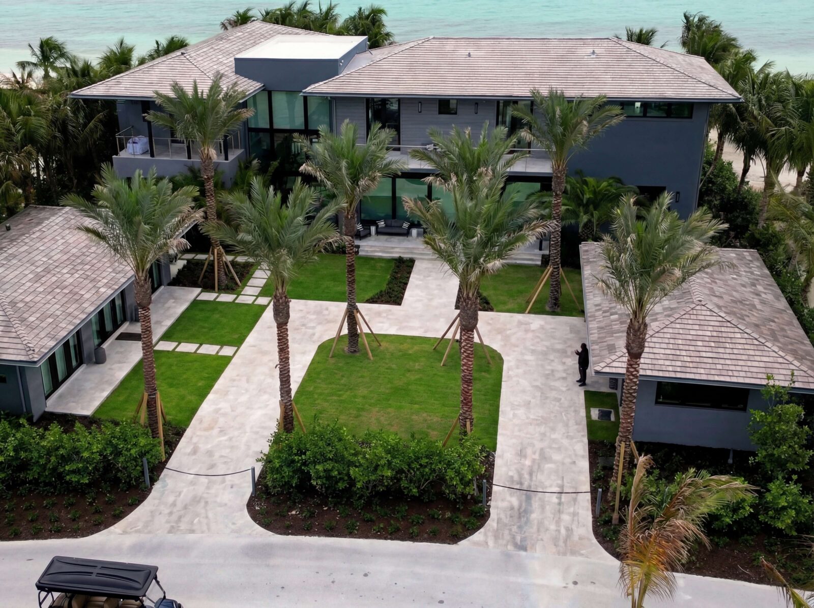 Aerial view of a coastal luxury residence with smart home automation, security, lighting, and integrated technology by Sound & Vision Technology